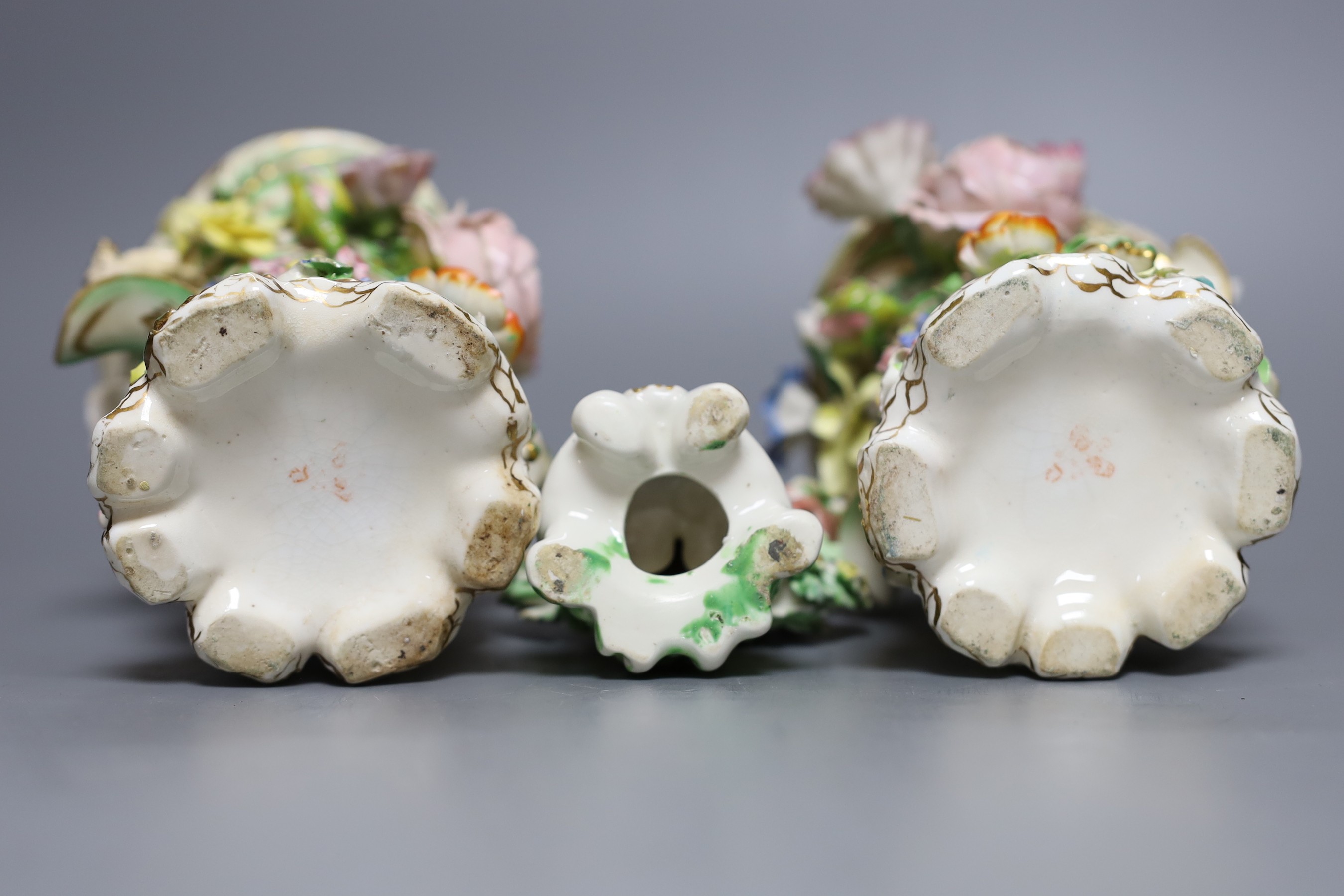 A 19th century Derby figure of a putti with flowers together with two floral encrusted porcelain vases, tallest 14cm
